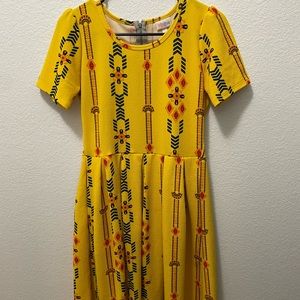 Beautiful bold yellow print dress. I’m 5’2 and it hits me at about my knees